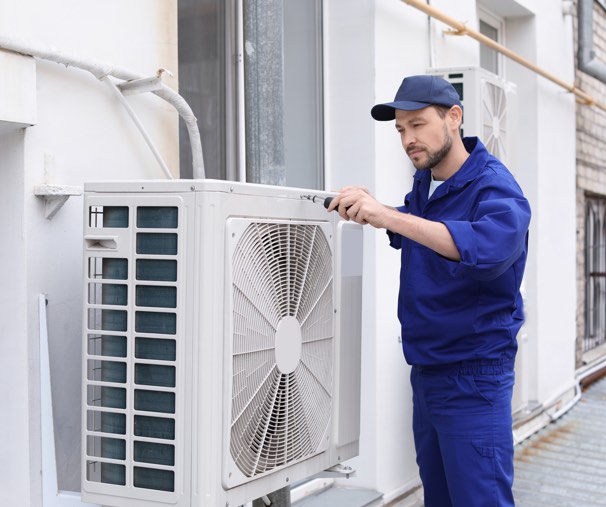 HVAC technician working on air conditioning system